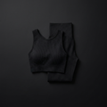 Women's seamless pilates crop top and high-waist leggings set on onyx background